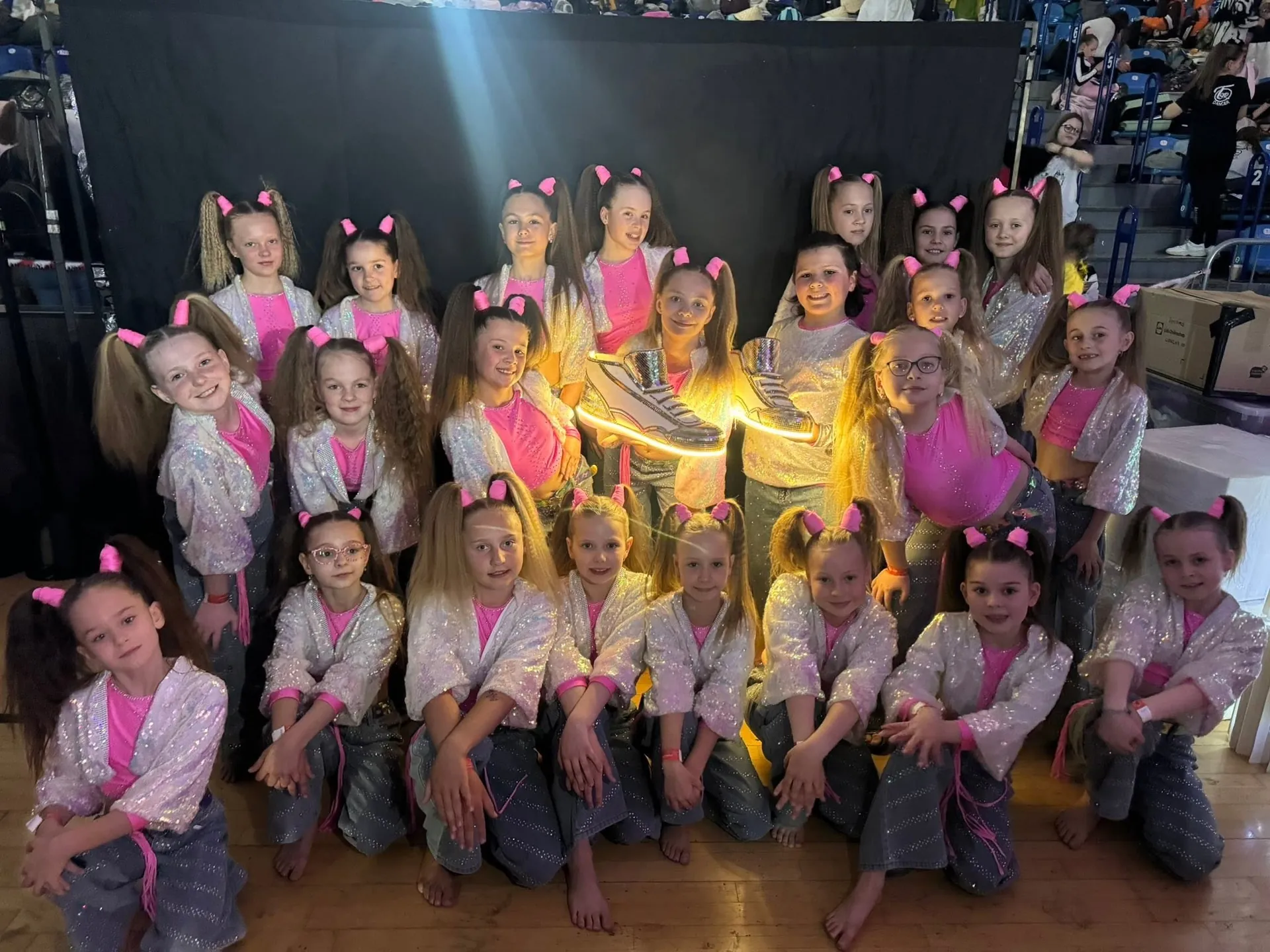 Taneční skupina Dance4Life s velkými svítícími botami vyrobenými 3D tiskem